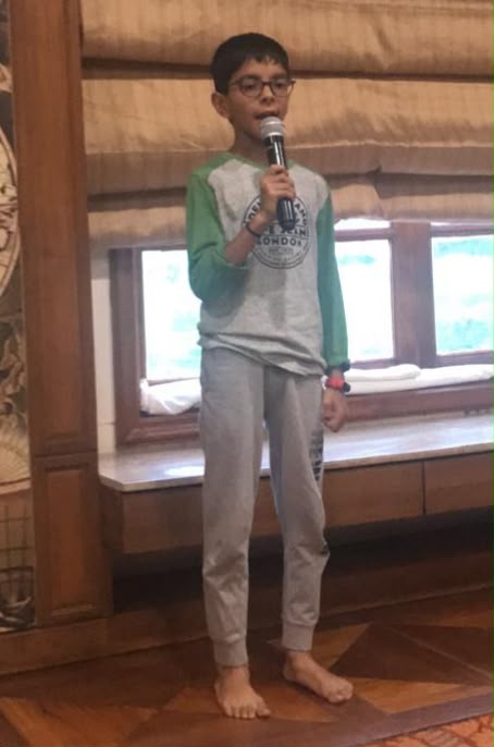 Young Kaabir speaking into a microphone